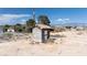Small outbuilding with stucco and tile roof, ideal for storage or a small workshop, located on the property at 480 China St, Pahrump, NV 89048