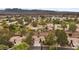 Wide aerial shot showcasing the neighborhood, green spaces, and mountain views at 4909 Ocean Shores Way, Las Vegas, NV 89130