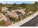 Stunning aerial view of a home with solar panels, lush landscaping, and a fenced yard at 4909 Ocean Shores Way, Las Vegas, NV 89130