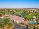 Aerial view of the community featuring a golf course, clubhouse, and serene ponds at 4909 Ocean Shores Way, Las Vegas, NV 89130