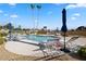Lounge chairs surround a community pool with tall palm trees at 4909 Ocean Shores Way, Las Vegas, NV 89130