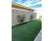 This backyard has beautiful green turf and pretty landscaping that is very low maintenance at 498 Pebble Run Ave, Henderson, NV 89011