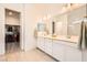 Bathroom featuring double sinks, and a view of the spacious walk-in closet at 498 Pebble Run Ave, Henderson, NV 89011