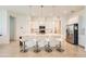 Open kitchen with white countertops, pendant lighting, stainless steel appliances, and barstool seating at 498 Pebble Run Ave, Henderson, NV 89011