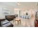 Bright and spacious living room seamlessly connected to the open-concept kitchen and dining area at 498 Pebble Run Ave, Henderson, NV 89011
