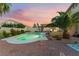 Spacious backyard with pool, spa, outdoor kitchen with built-in BBQ and comfortable patio seating at 5350 Sharon Marie Ct, Las Vegas, NV 89118