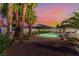 Private backyard features desert landscaping, mature palms, a pool, and outdoor seating area at 5350 Sharon Marie Ct, Las Vegas, NV 89118