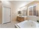 Bright bathroom features double sinks, soaking tub and window at 5350 Sharon Marie Ct, Las Vegas, NV 89118