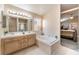 Bright bathroom with double sinks, soaking tub and view to bedroom at 5350 Sharon Marie Ct, Las Vegas, NV 89118