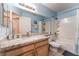 Bright bathroom featuring granite counters, a full mirror, a shower, and tub combination, providing a functional space at 5350 Sharon Marie Ct, Las Vegas, NV 89118