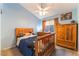 Cozy bedroom with blue walls, ceiling fan, and wood furnishings at 5350 Sharon Marie Ct, Las Vegas, NV 89118