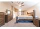 Bright bedroom features a ceiling fan, neutral walls, and wood furniture set at 5350 Sharon Marie Ct, Las Vegas, NV 89118
