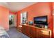 Bedroom features an orange wall, large window, and wood furniture at 5350 Sharon Marie Ct, Las Vegas, NV 89118