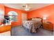 Bedroom with orange walls and filled with natural light from window at 5350 Sharon Marie Ct, Las Vegas, NV 89118
