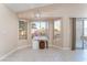 Bright dining area with desk, tiled flooring, and large windows offering backyard views at 5350 Sharon Marie Ct, Las Vegas, NV 89118