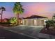 Charming home with a three-car garage, desert landscaping, and mature palm trees at 5350 Sharon Marie Ct, Las Vegas, NV 89118