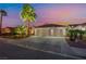 Charming home with a three-car garage, desert landscaping, and mature palm trees at 5350 Sharon Marie Ct, Las Vegas, NV 89118