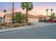 Charming single-story home with a spacious three-car garage, complimented by desert landscaping and mature palm trees at 5350 Sharon Marie Ct, Las Vegas, NV 89118