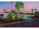Exterior view of a charming home with a well-maintained lawn, mature trees, and a three-car garage at 5350 Sharon Marie Ct, Las Vegas, NV 89118
