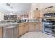 Open kitchen with granite countertops, stainless steel appliances, and adjacent dining area at 5350 Sharon Marie Ct, Las Vegas, NV 89118