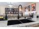 Close up on kitchen sink with black faucet and granite countertops at 5350 Sharon Marie Ct, Las Vegas, NV 89118