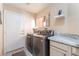 Laundry room including a side-by-side washer and dryer, overhead light and access to an exterior door at 5350 Sharon Marie Ct, Las Vegas, NV 89118