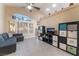 Inviting living room with tile floors, storage shelves, and a comfortable gray sofa creating a cozy atmosphere at 5350 Sharon Marie Ct, Las Vegas, NV 89118
