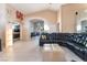 Open-concept living room with tile flooring, modern decor, and a large sectional sofa for comfortable lounging at 5350 Sharon Marie Ct, Las Vegas, NV 89118