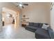 Bright open-concept living room featuring a gray sofa, tile flooring, and direct access to other living spaces at 5350 Sharon Marie Ct, Las Vegas, NV 89118