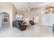 Spacious living room featuring tile floors, a large mirror, vaulted ceiling, and comfortable leather furniture at 5350 Sharon Marie Ct, Las Vegas, NV 89118