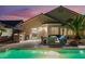 Outdoor living with a covered patio, built-in grill, dining area, and pool access at 5350 Sharon Marie Ct, Las Vegas, NV 89118