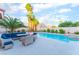 Beautiful backyard oasis with a pool, spa, palm trees, patio seating, and lush landscaping, great for outdoor enjoyment at 5350 Sharon Marie Ct, Las Vegas, NV 89118