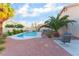 Landscaped backyard featuring a beautiful pool, spa, palm trees, patio, plants, and gravel ground cover at 5350 Sharon Marie Ct, Las Vegas, NV 89118