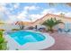 Inviting backyard featuring a refreshing pool, desert landscaping, and a comfortable outdoor seating area, perfect for relaxing at 5350 Sharon Marie Ct, Las Vegas, NV 89118