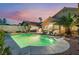 Beautiful backyard with pool, spa, outdoor kitchen with built-in BBQ and comfortable patio seating at 5350 Sharon Marie Ct, Las Vegas, NV 89118