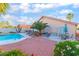 Inviting backyard featuring a refreshing pool, desert landscaping, and a comfortable outdoor seating area, ideal for relaxation at 5350 Sharon Marie Ct, Las Vegas, NV 89118