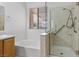 Bathroom featuring tiled shower and tub, single vanity and neutral walls at 538 Ancient Mayan Dr, Henderson, NV 89015