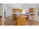 Bright eat-in kitchen featuring tile floors, an island, modern appliances and oak cabinets at 538 Ancient Mayan Dr, Henderson, NV 89015