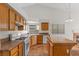Bright eat-in kitchen featuring tile floors, an island, modern appliances and oak cabinets at 538 Ancient Mayan Dr, Henderson, NV 89015