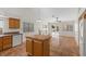 Bright, open concept showcasing the tile floors, fireplace, kitchen with island and sliding doors to yard at 538 Ancient Mayan Dr, Henderson, NV 89015