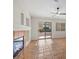Bright living room featuring tile floors, fireplace, and sliding glass doors to the backyard at 538 Ancient Mayan Dr, Henderson, NV 89015