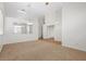 Open-concept living area with a combination of neutral carpeting and tile flooring, ideal for modern living and entertaining at 538 Ancient Mayan Dr, Henderson, NV 89015