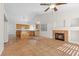 Open living room with vaulted ceiling, tile floors, a fireplace and adjacent kitchen area at 538 Ancient Mayan Dr, Henderson, NV 89015