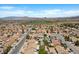 An aerial view showcases a tranquil residential area with houses and a green golf course nearby at 538 Ancient Mayan Dr, Henderson, NV 89015