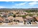 A daytime aerial view shows houses in a residential neighborhood against a mountain backdrop at 538 Ancient Mayan Dr, Henderson, NV 89015