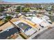 Aerial view showcasing the home's fenced yard within a vibrant neighborhood setting, with city and mountain views at 5580 Waltham Ln, Las Vegas, NV 89122
