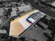 An aerial view showcases the house, its detached garage, and a large vacant lot ready for customization at 5580 Waltham Ln, Las Vegas, NV 89122