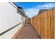 Long gravel section of backyard with wooden fence at 5580 Waltham Ln, Las Vegas, NV 89122