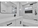 Modern bathroom featuring marble tile, black fixtures, and a bright white vanity at 5580 Waltham Ln, Las Vegas, NV 89122