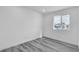 Inviting bedroom featuring new flooring and a bright window view at 5580 Waltham Ln, Las Vegas, NV 89122